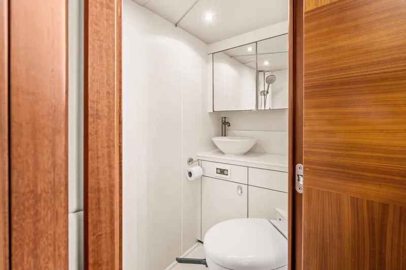 Slide: The Image of Modern bathroom on a 2014 Sunseeker 75 Yacht with wooden door and white fixtures. - 38