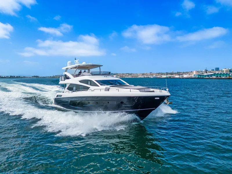 Slide: The Image of 2014 Sunseeker 75 Yacht cruising on open water under a clear blue sky. - 39