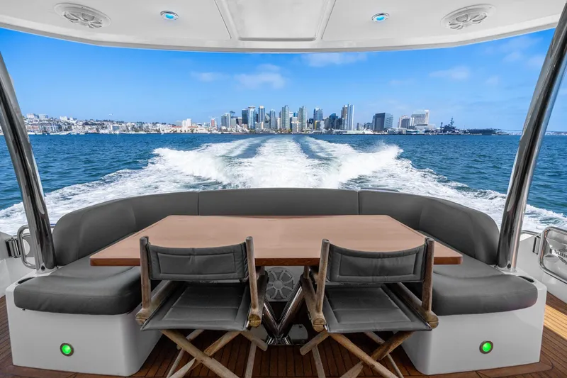Slide: The Image of View from the 2014 Sunseeker 75 Yacht, overlooking city skyline and ocean wake. - 49