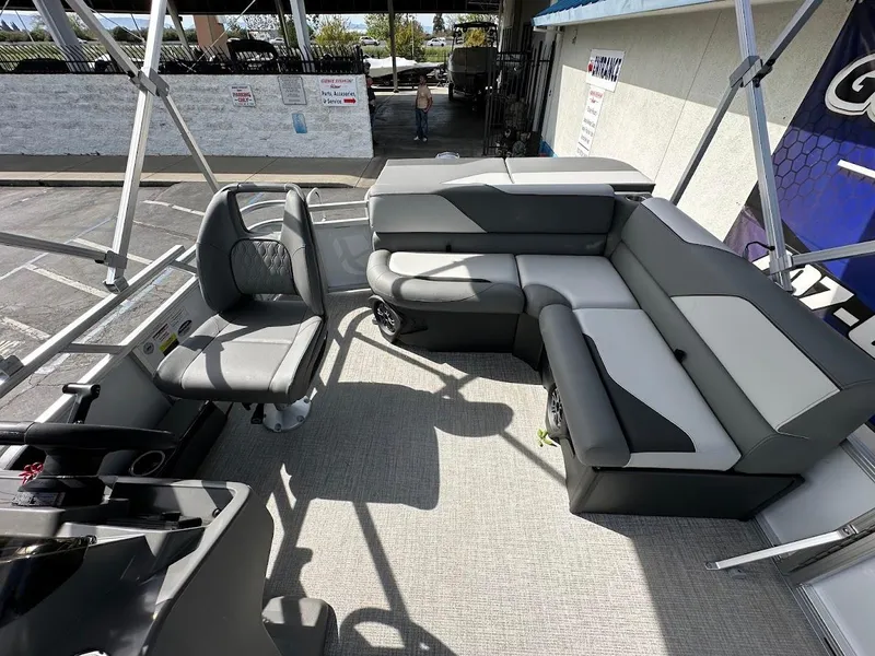 Slide: The Image of 2024 Tahoe Pontoon Sport Cruise Bow Fish interior with seating and helm. - 16
