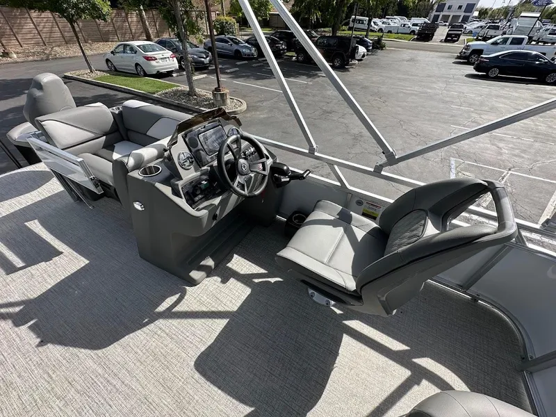 Slide: The Image of 2024 Tahoe Pontoon Sport Cruise Bow Fish interior with steering console and seating. - 18