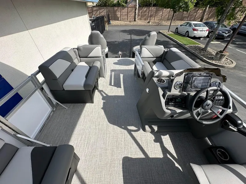 Slide: The Image of 2024 Tahoe Pontoon Sport Cruise Bow Fish interior with seating and steering console. - 19