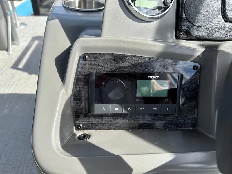 Slide: The Image of 2024 Tahoe Pontoon Sport Cruise Bow Fish dashboard with Fusion stereo system. - 23