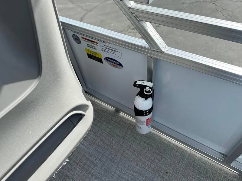 Slide: The Image of 2024 Tahoe Pontoon Sport Cruise Bow Fish interior with mounted fire extinguisher. - 25