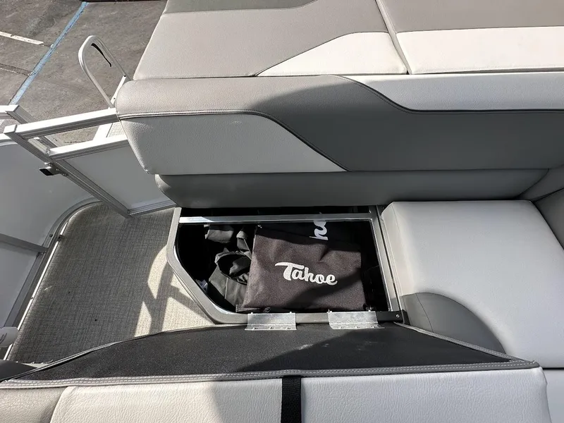 Slide: The Image of 2024 Tahoe Pontoon Sport Cruise Bow Fish storage compartment with Tahoe bag. - 31
