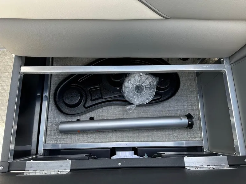 Slide: The Image of Storage compartment of 2024 Tahoe Pontoon Sport Cruise Bow Fish boat with accessories. - 35
