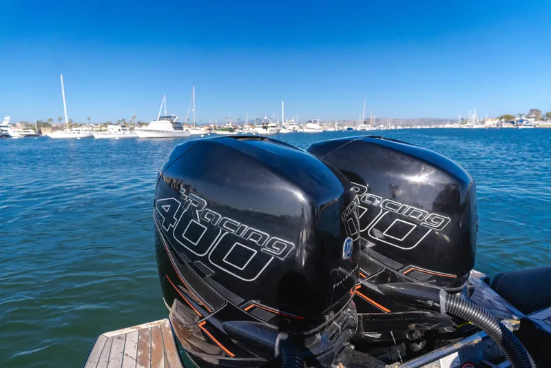 Slide: The Image of Twin outboard engines on a 2019 Technohull 34 Sea DNA 999 boat in a marina. - 25