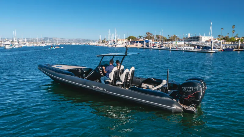 Slide: The Image of 2019 Technohull 34 Sea DNA 999 boat cruising in a marina with clear blue water. - 8
