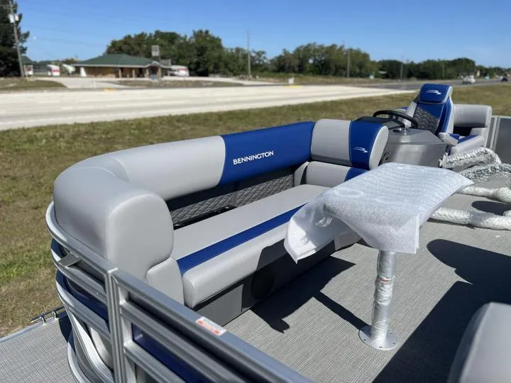 Slide: The Image of 2024 Bennington S 20 SSR pontoon boat with blue and gray seating. - 10