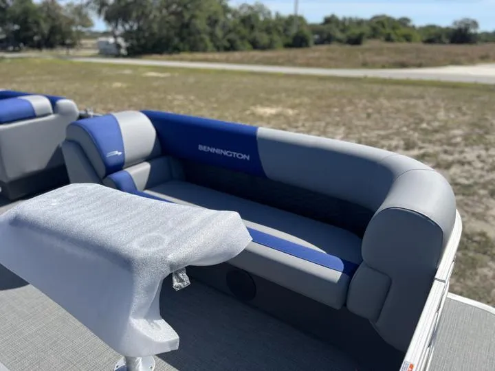 Slide: The Image of 2024 Bennington S 20 SSR pontoon boat with blue and gray seating. - 11