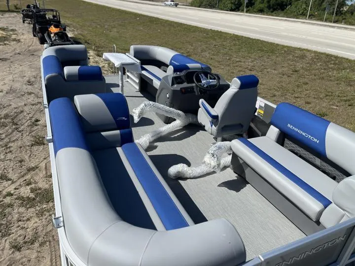 Slide: The Image of 2024 Bennington S 20 SSR pontoon boat with blue and gray seating. - 16