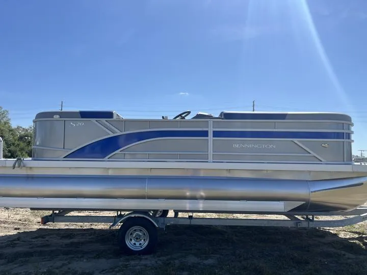 Slide: The Image of 2024 Bennington S 20 SSR pontoon boat on trailer under clear blue sky. - 8