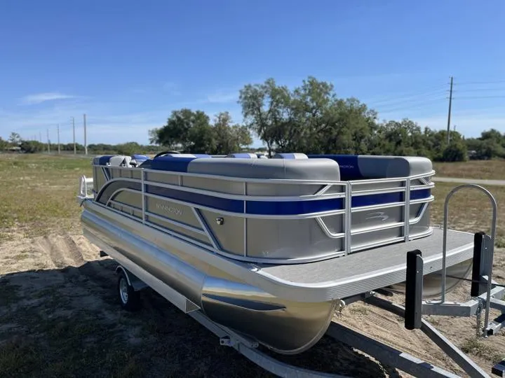 Slide: The Image of 2024 Bennington S 20 SSR pontoon boat on trailer in outdoor setting. - 9