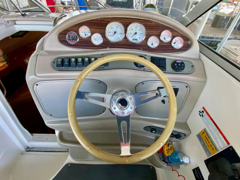 Slide: The Image of 2008 Larson Cabrio 240 boat dashboard with steering wheel and gauges. - 10