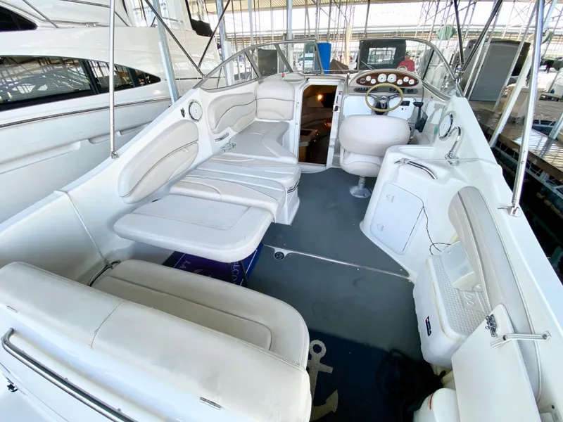 Slide: The Image of 2008 Larson Cabrio 240 boat interior with white seating and helm. - 13