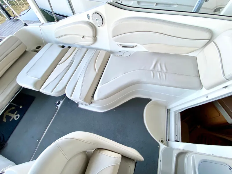Slide: The Image of 2008 Larson Cabrio 240 boat interior with white leather seating and modern design. - 14