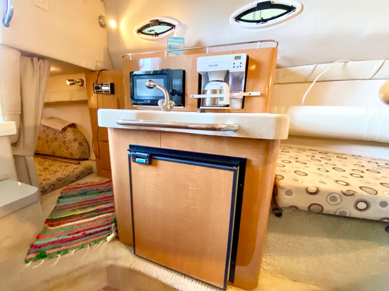 Slide: The Image of 2008 Larson Cabrio 240 interior kitchen with microwave, coffee maker, and mini-fridge. - 16