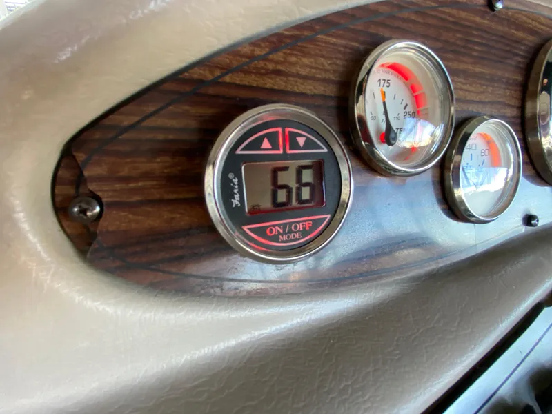 Slide: The Image of 2008 Larson Cabrio 240 dashboard with digital and analog gauges. - 25
