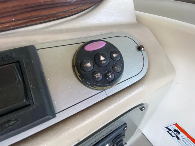 Slide: The Image of 2008 Larson Cabrio 240 boat control panel with volume and band buttons. - 28