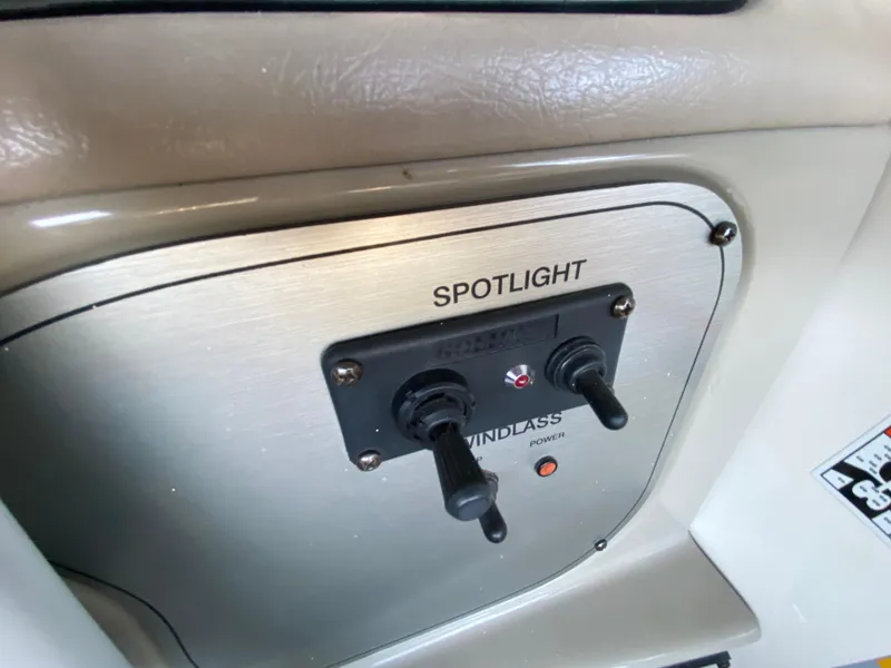 Slide: The Image of Control panel of a 2008 Larson Cabrio 240 boat with spotlight and windlass switches. - 29