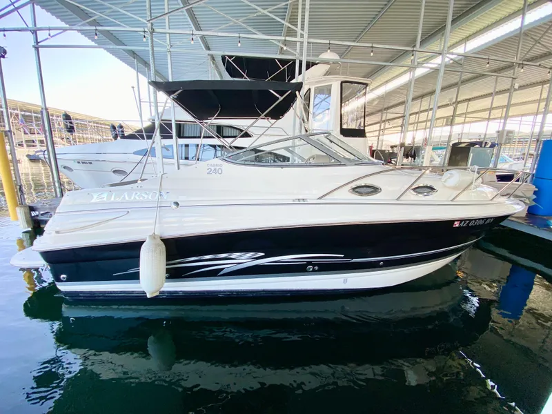 Slide: The Image of 2008 Larson Cabrio 240 boat docked in a marina. - 3
