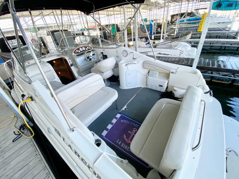 Slide: The Image of 2008 Larson Cabrio 240 boat interior at marina dock. - 5