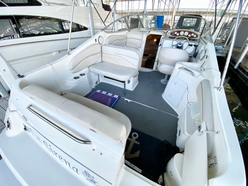 Slide: The Image of 2008 Larson Cabrio 240 boat interior with white seating and dashboard. - 6