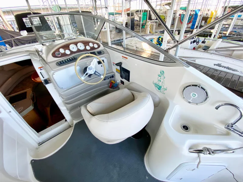 Slide: The Image of 2008 Larson Cabrio 240 boat cockpit with steering wheel and control panel. - 7
