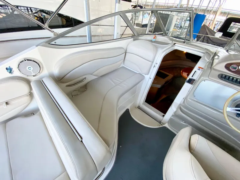 Slide: The Image of Interior of a 2008 Larson Cabrio 240 boat with white leather seating. - 8