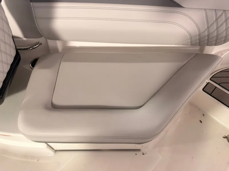 Slide: The Image of The 2024 Sea Ray SLX 260 Surf features sleek, upholstered seating with a modern design. - 23