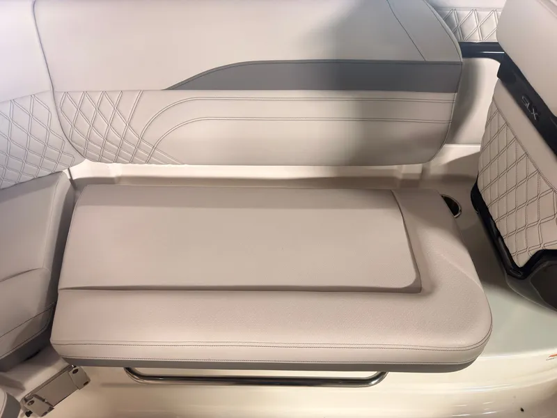 Slide: The Image of The 2024 Sea Ray SLX 260 Surf features an elegant, upholstered bench seat with quilted design. - 20