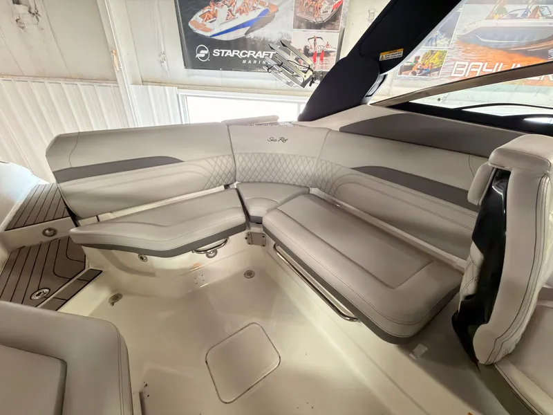 Slide: The Image of Interior of a 2024 Sea Ray SLX 260 Surf with sleek, gray upholstered seating. - 15