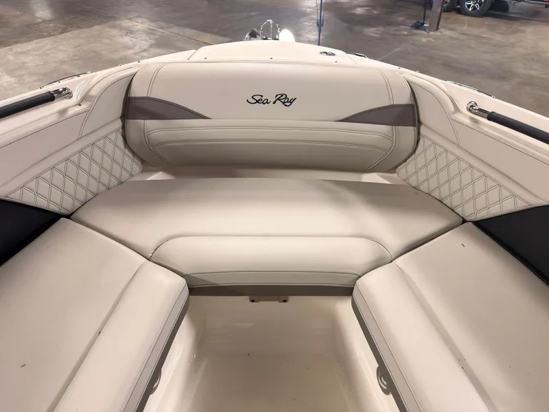 Slide: The Image of The 2024 Sea Ray SLX 260 Surf features an elegant, cushioned seating area with quilted detailing. - 46