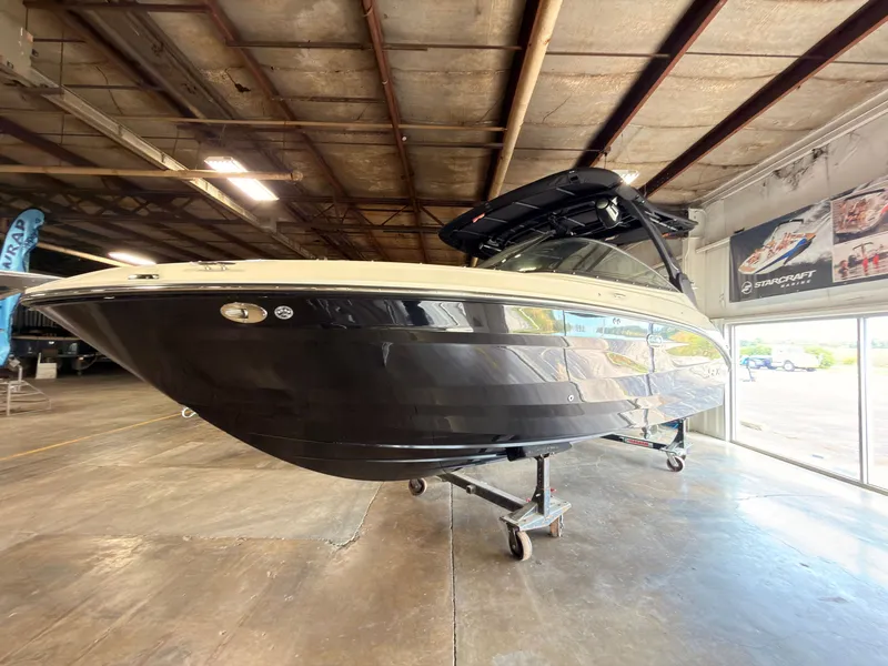 Slide: The Image of A 2024 Sea Ray SLX 260 Surf boat is in a warehouse on a trailer. - 3