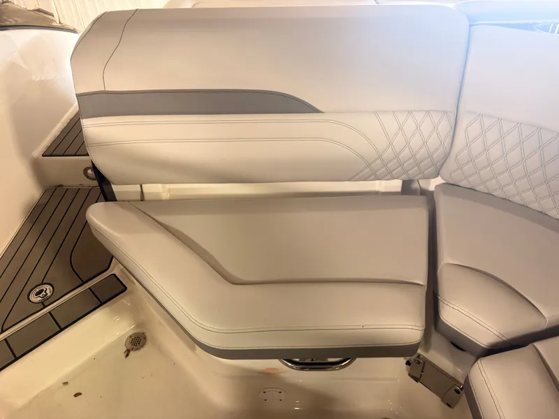 Slide: The Image of The interior of the 2024 Sea Ray SLX 260 Surf features sleek, upholstered seating with modern stitching. - 16