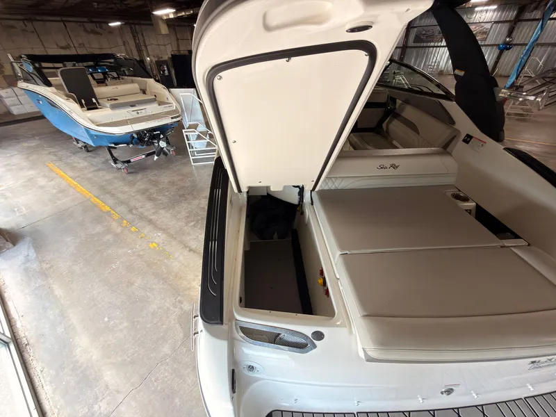 Slide: The Image of A 2024 Sea Ray SLX 260 Surf in a warehouse. View of the open stern area. - 11