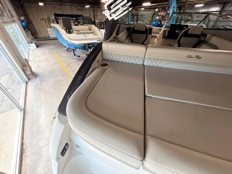 Slide: The Image of Interior view of a 2024 Sea Ray SLX 260 Surf with beige upholstery. - 10