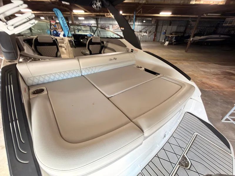 Slide: The Image of The image shows the spacious aft deck of a 2024 Sea Ray SLX 260 Surf. - 13