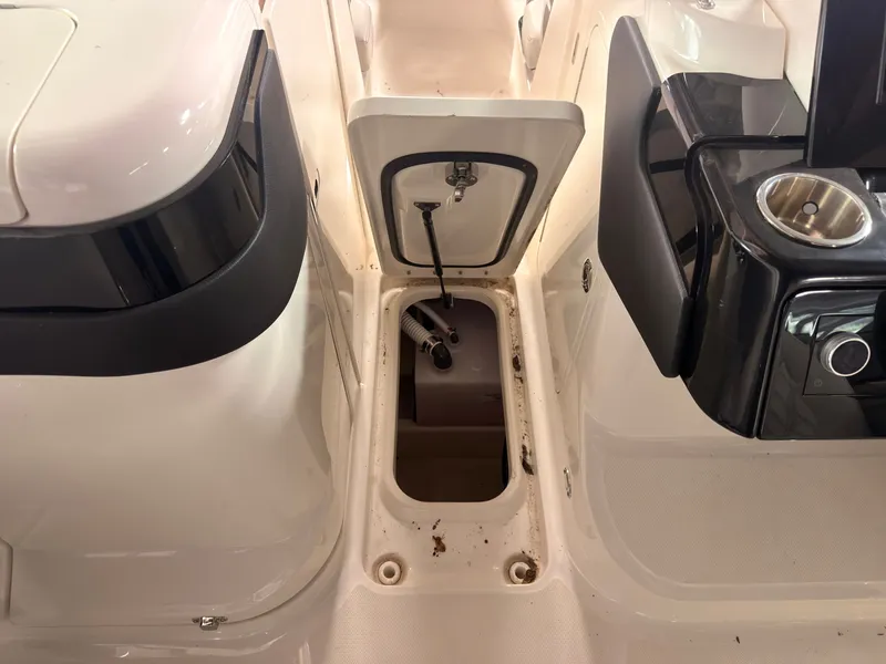 Slide: The Image of An open storage compartment on a 2024 Sea Ray SLX 260 Surf boat, surrounded by white surfaces. - 41