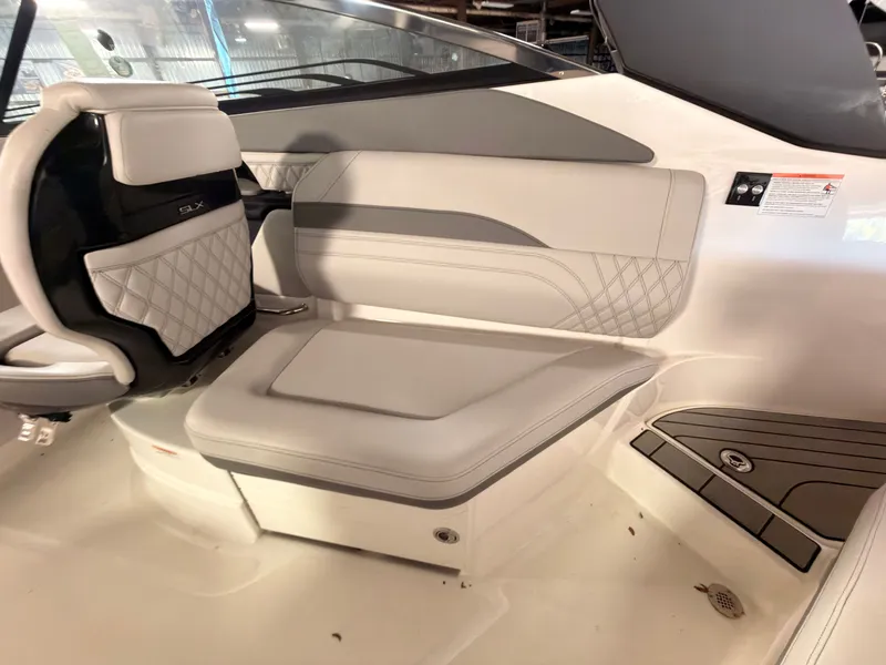 Slide: The Image of Interior of a 2024 Sea Ray SLX 260 Surf with sleek, upholstered seating and modern design. - 22