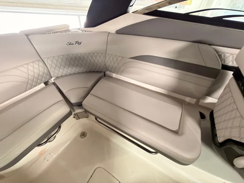Slide: The Image of The 2024 Sea Ray SLX 260 Surf features luxurious, cushioned seating with a quilted design. - 19