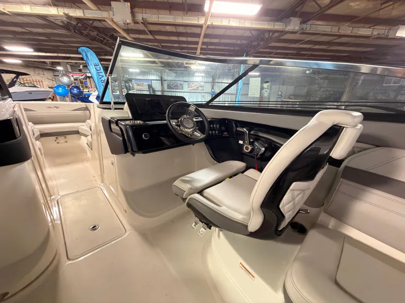 Slide: The Image of The image shows the cockpit of a 2024 Sea Ray SLX 260 Surf with a modern helm. - 31