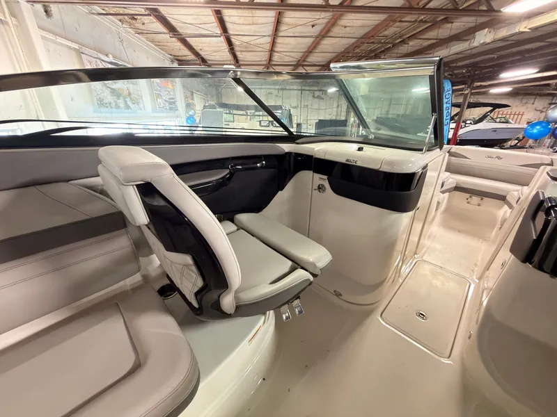 Slide: The Image of Interior view of a 2024 Sea Ray SLX 260 Surf with beige seating and modern design. - 26