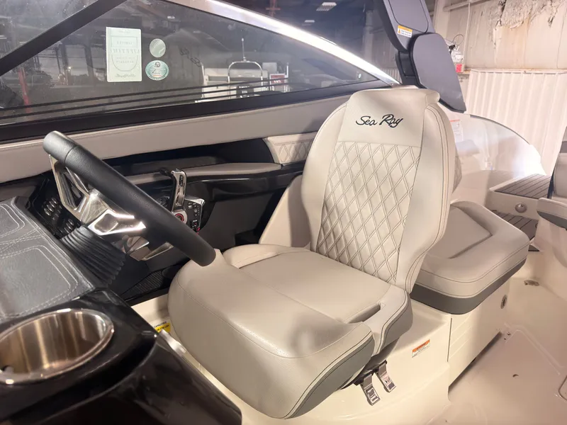 Slide: The Image of The interior of the 2024 Sea Ray SLX 260 Surf features a sleek, upholstered seat and modern dashboard. - 32