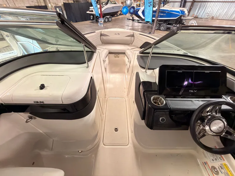 Slide: The Image of The image shows the cockpit of a 2024 Sea Ray SLX 260 Surf boat with modern instruments. - 40