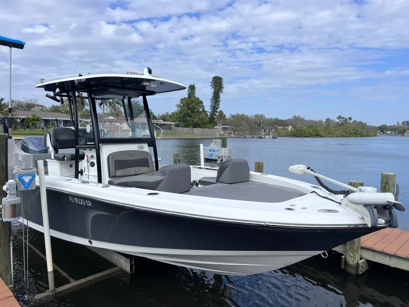 Slide: The Image of 2020 Crevalle 26 HCO Yamaha 300 boat docked by a scenic waterfront. - 16