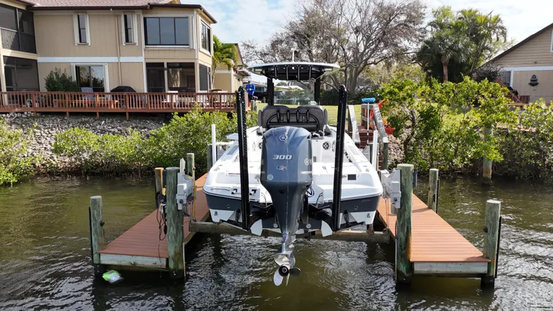 Slide: The Image of 2020 Crevalle 26 HCO Yamaha 300 boat docked at waterfront property. - 2