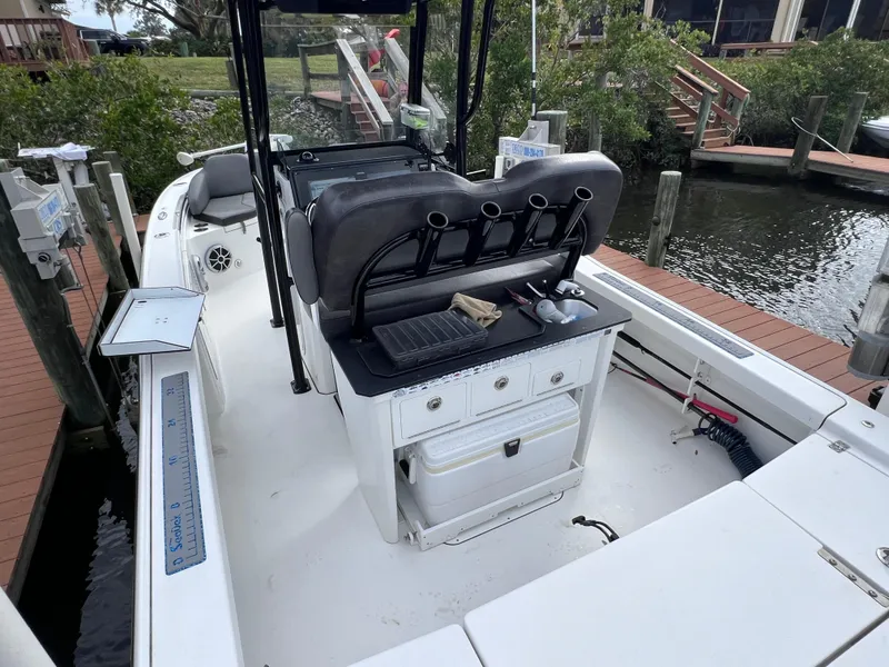 Slide: The Image of 2020 Crevalle 26 HCO Yamaha 300 boat interior with fishing rod holders and storage compartments. - 25