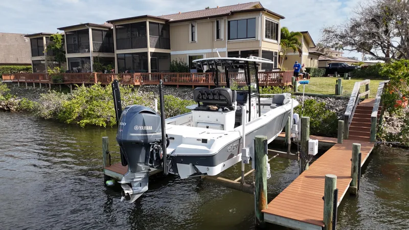 Slide: The Image of 2020 Crevalle 26 HCO Yamaha 300 boat docked by waterfront homes. - 3