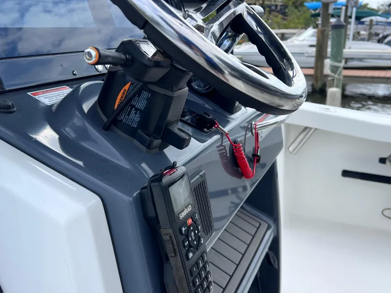 Slide: The Image of 2020 Crevalle 26 HCO Yamaha 300 boat steering console with radio and safety lanyard. - 31